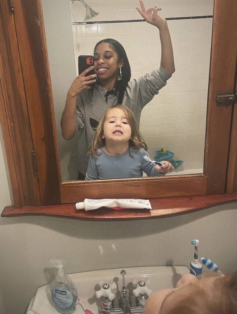 Child brushing teeth with Nina the Nanny with her