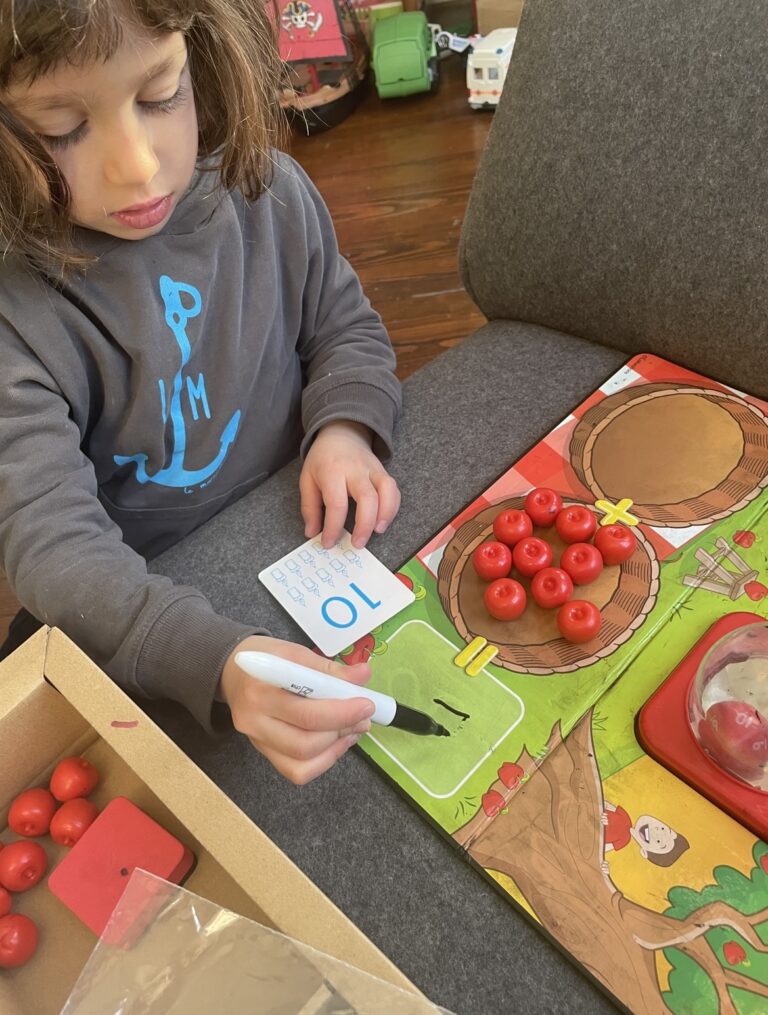 Child receiving homework assistance from Nina the Nanny in after-school care